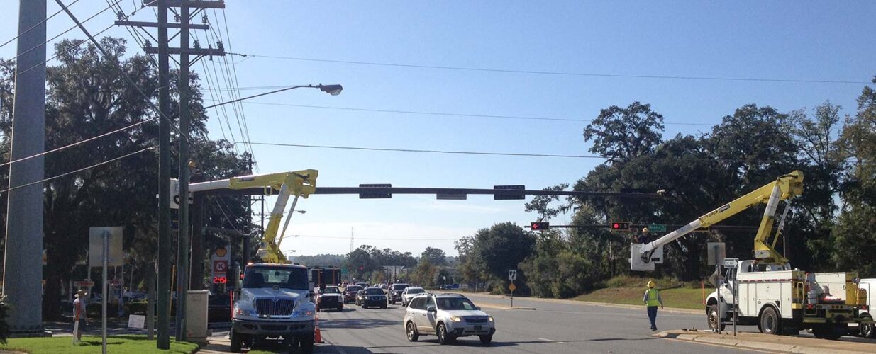 trucks and workers at traffic stop intersection